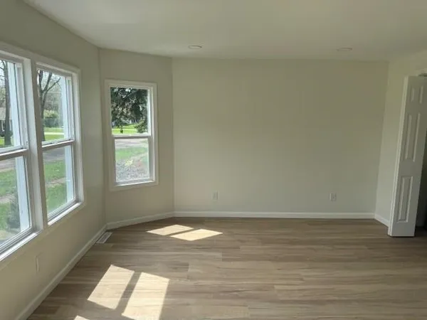 a kitchen with a sink cabinets and wooden floor