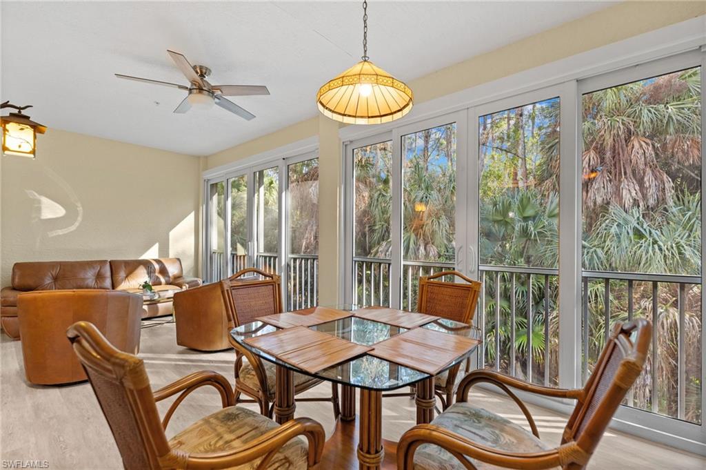 1665 Winding Oaks Way, Unit 202 Naples, FL 34109 - Photo 11 of 34 Sunroom with wood finished floors