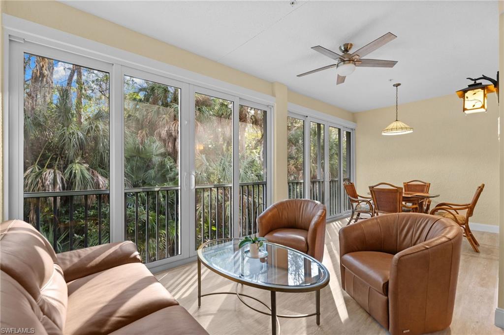 1665 Winding Oaks Way, Unit 202 Naples, FL 34109 - Photo 12 of 34 Sunroom / solarium featuring wood finished floors and vaulted ceiling