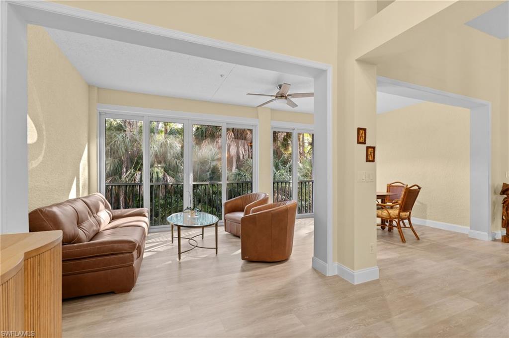 1665 Winding Oaks Way, Unit 202 Naples, FL 34109 - Photo 13 of 34 Sunroom featuring wood finished floors and healthy amount of natural light