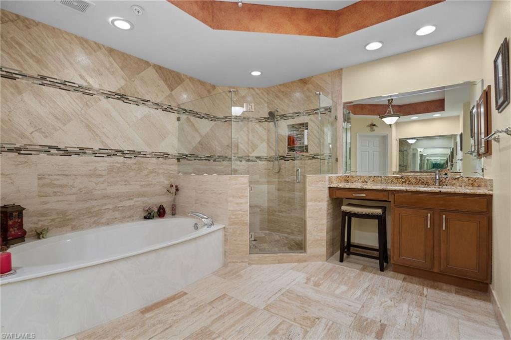 1665 Winding Oaks Way, Unit 202 Naples, FL 34109 - Photo 22 of 34 Bathroom featuring vanity, a stall shower, a bath, and recessed lighting
