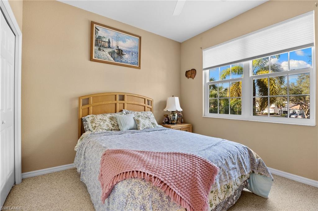 1665 Winding Oaks Way, Unit 202 Naples, FL 34109 - Photo 24 of 34 Carpeted bedroom with a closet and a ceiling fan