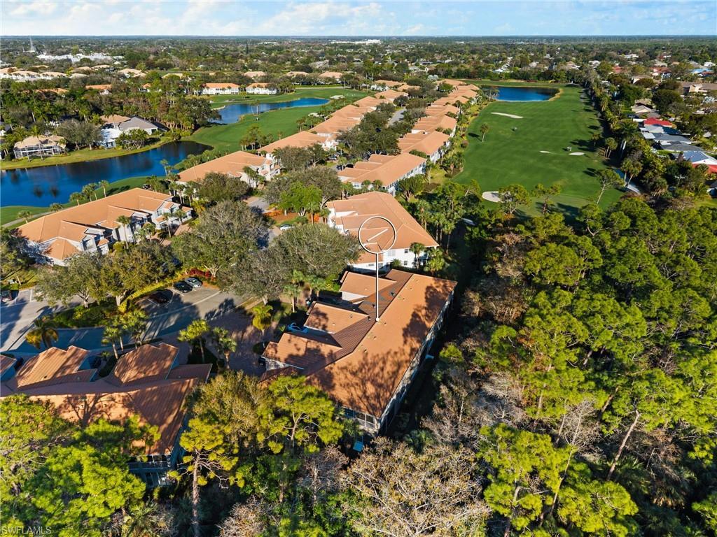 1665 Winding Oaks Way, Unit 202 Naples, FL 34109 - Photo 29 of 34 Aerial view of residential area with a nearby body of water and a golf club