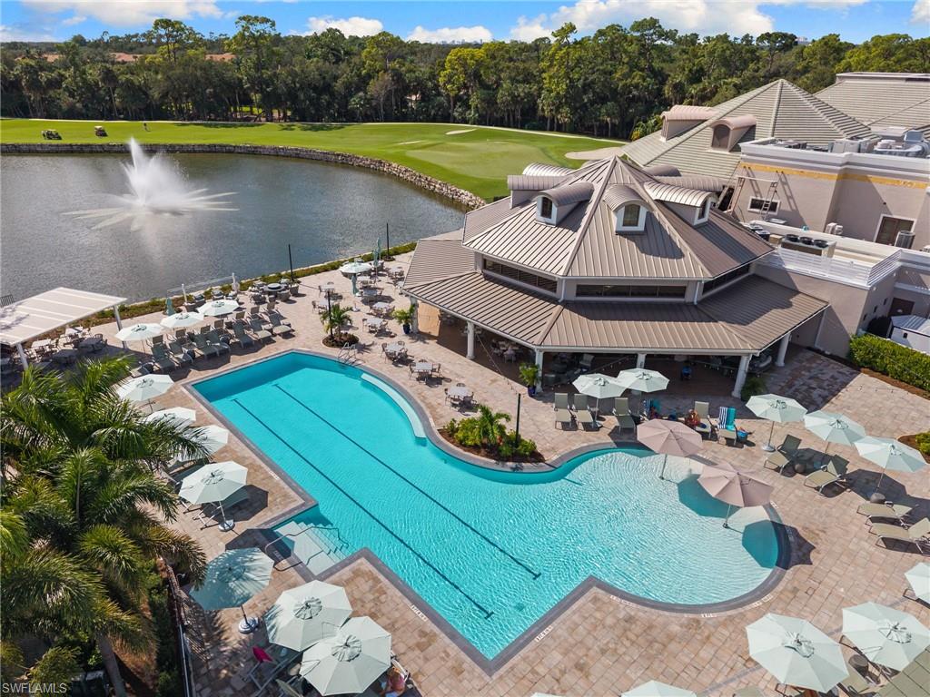 1665 Winding Oaks Way, Unit 202 Naples, FL 34109 - Photo 32 of 34 Community pool with view of wooded area, a patio area, a water view, and golf course view
