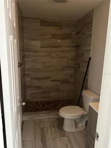 a bathroom with a toilet and a shower