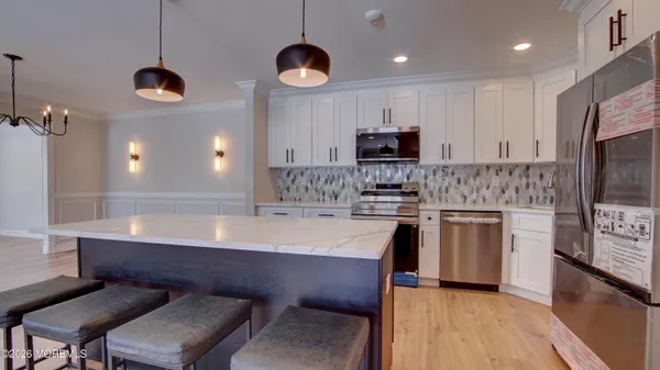 a kitchen with kitchen island granite countertop a sink counter space stainless steel appliances and cabinets