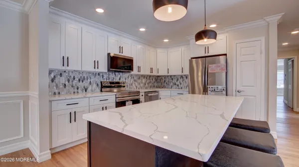 a kitchen with stainless steel appliances a refrigerator sink and microwave