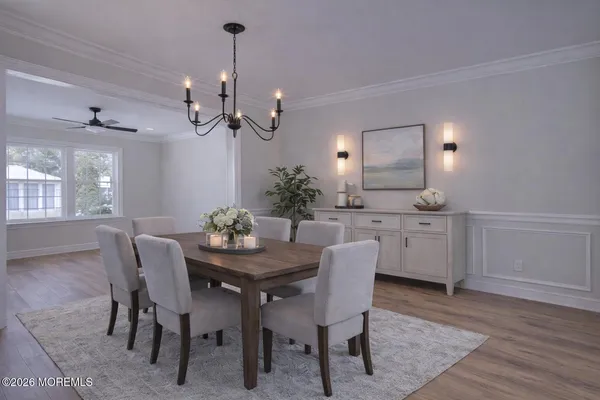 a dining room with furniture a chandelier and wooden floor