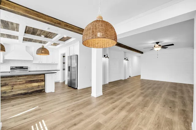 a view of a livingroom with furniture and chandelier fan
