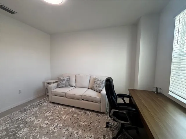 a living room with furniture and a window