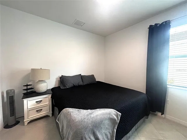 a bedroom with a bed and a window