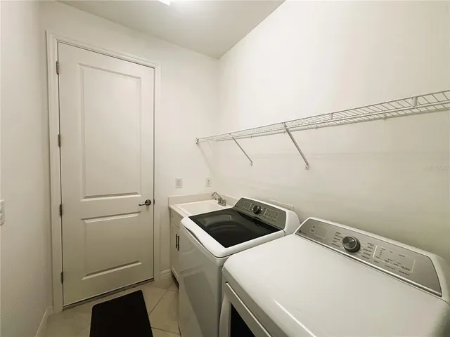 a view of storage and utility room with washer and dryer