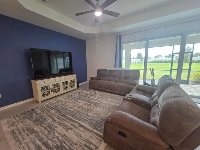 a living room with couches and a flat screen tv