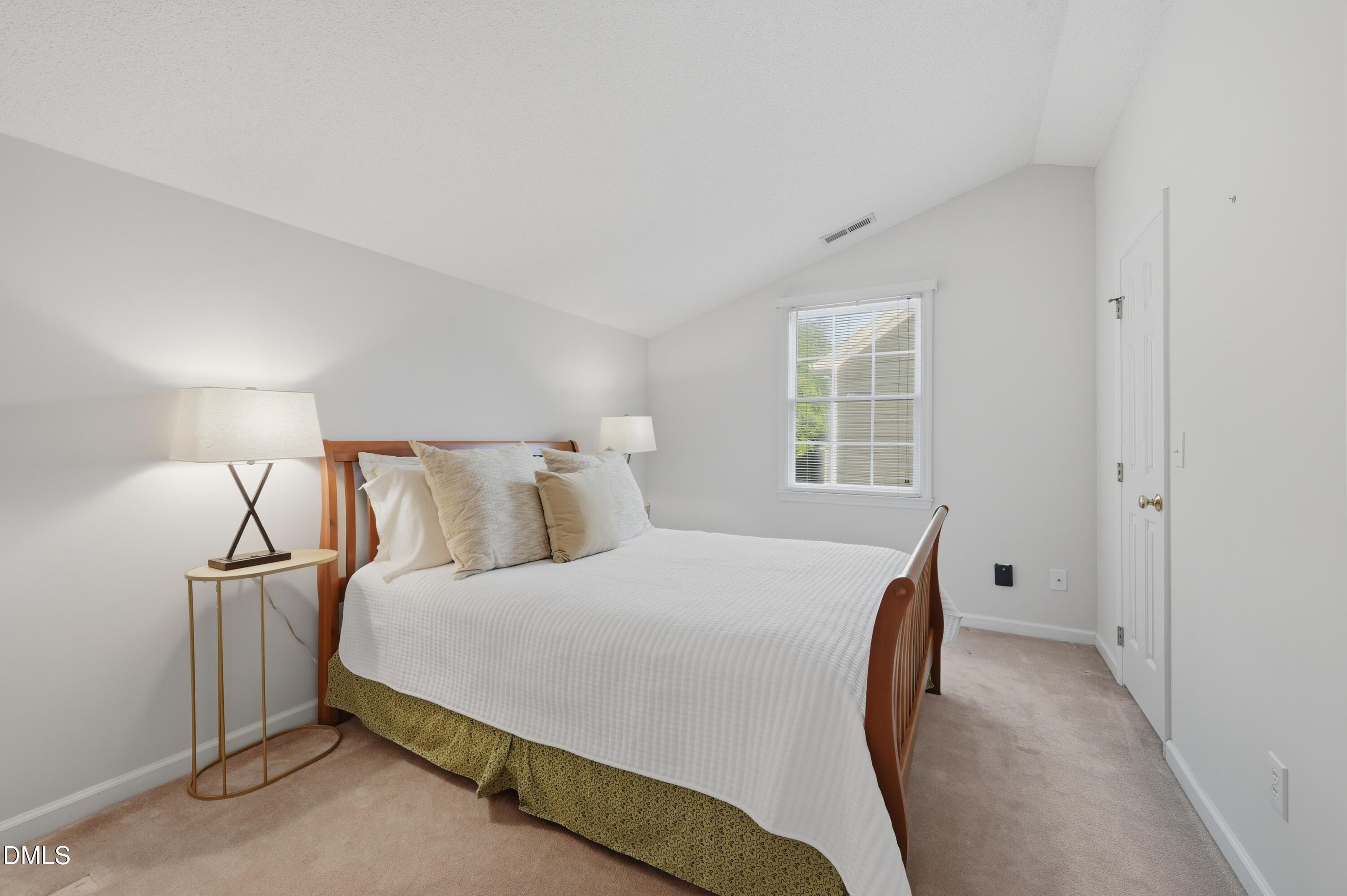 6801 Lynnoak Drive Raleigh, NC 27613 - Photo 17 of 30 a bedroom with a bed and window