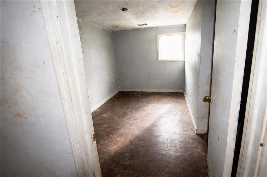 731 Bolton Road Northwest Atlanta, GA 30331 - Photo 11 of 20 an empty room with wooden floor and windows