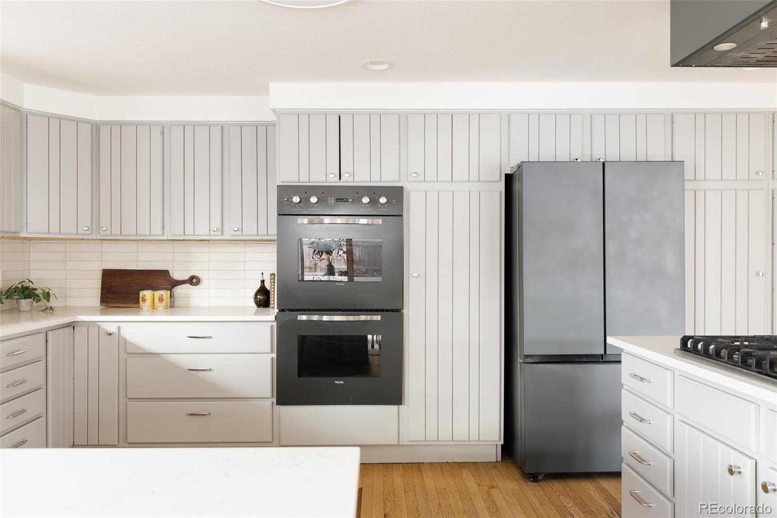 4035 Cody Street Wheat Ridge, CO 80033 - Photo 20 of 47 a kitchen with a refrigerator sink and cabinets