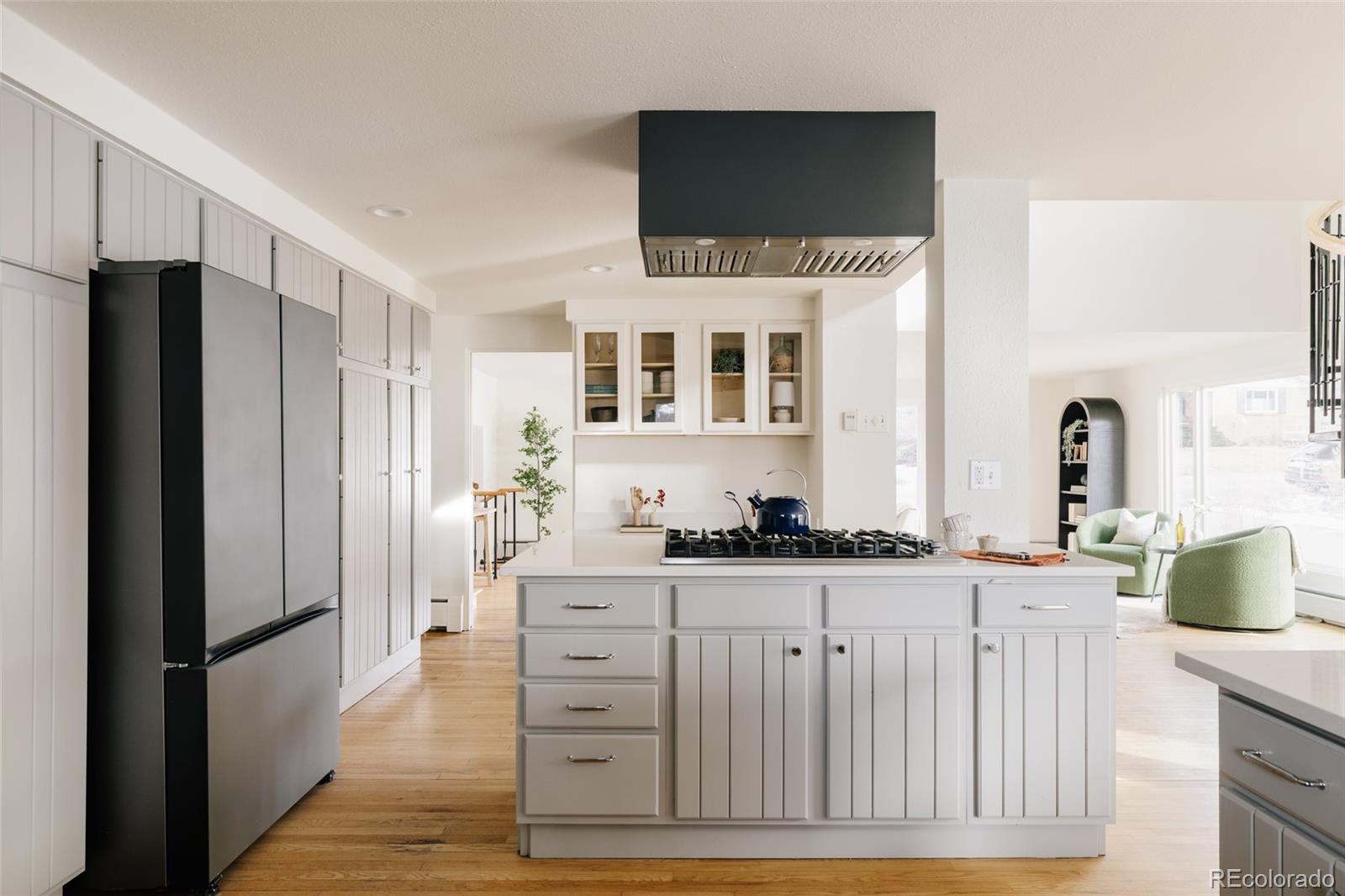 4035 Cody Street Wheat Ridge, CO 80033 - Photo 21 of 47 a kitchen with stainless steel appliances kitchen island granite countertop a refrigerator stove and sink