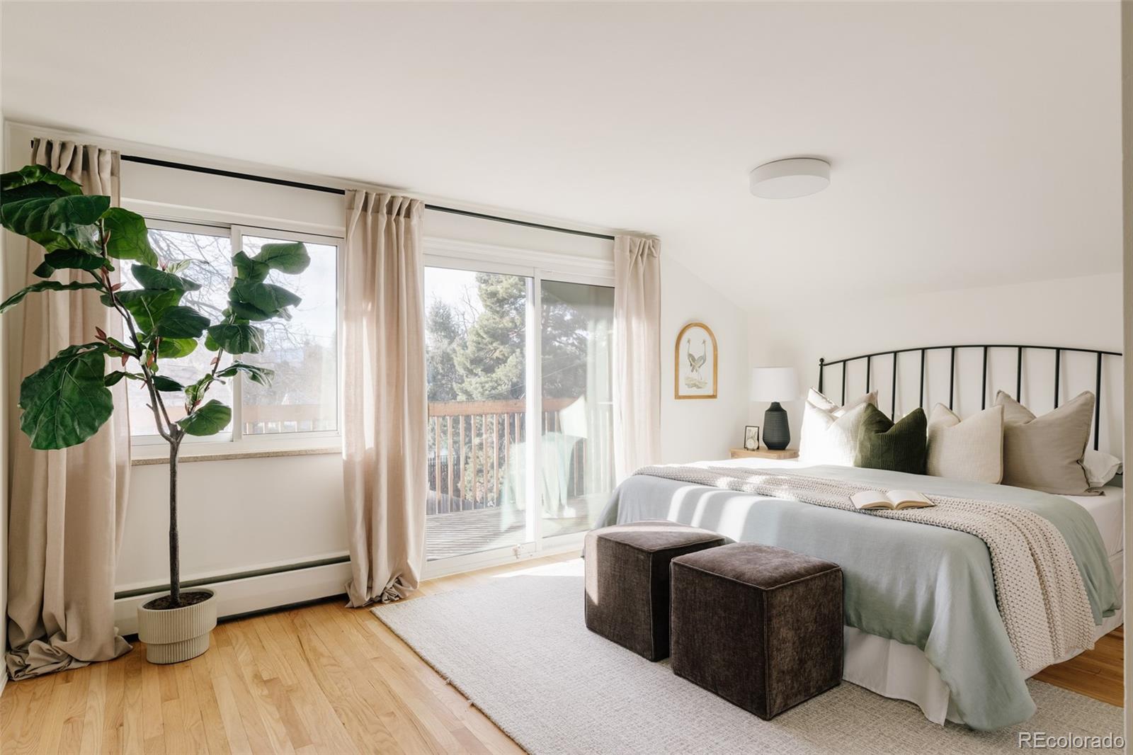 4035 Cody Street Wheat Ridge, CO 80033 - Photo 26 of 47 a bedroom with bed and a potted plant