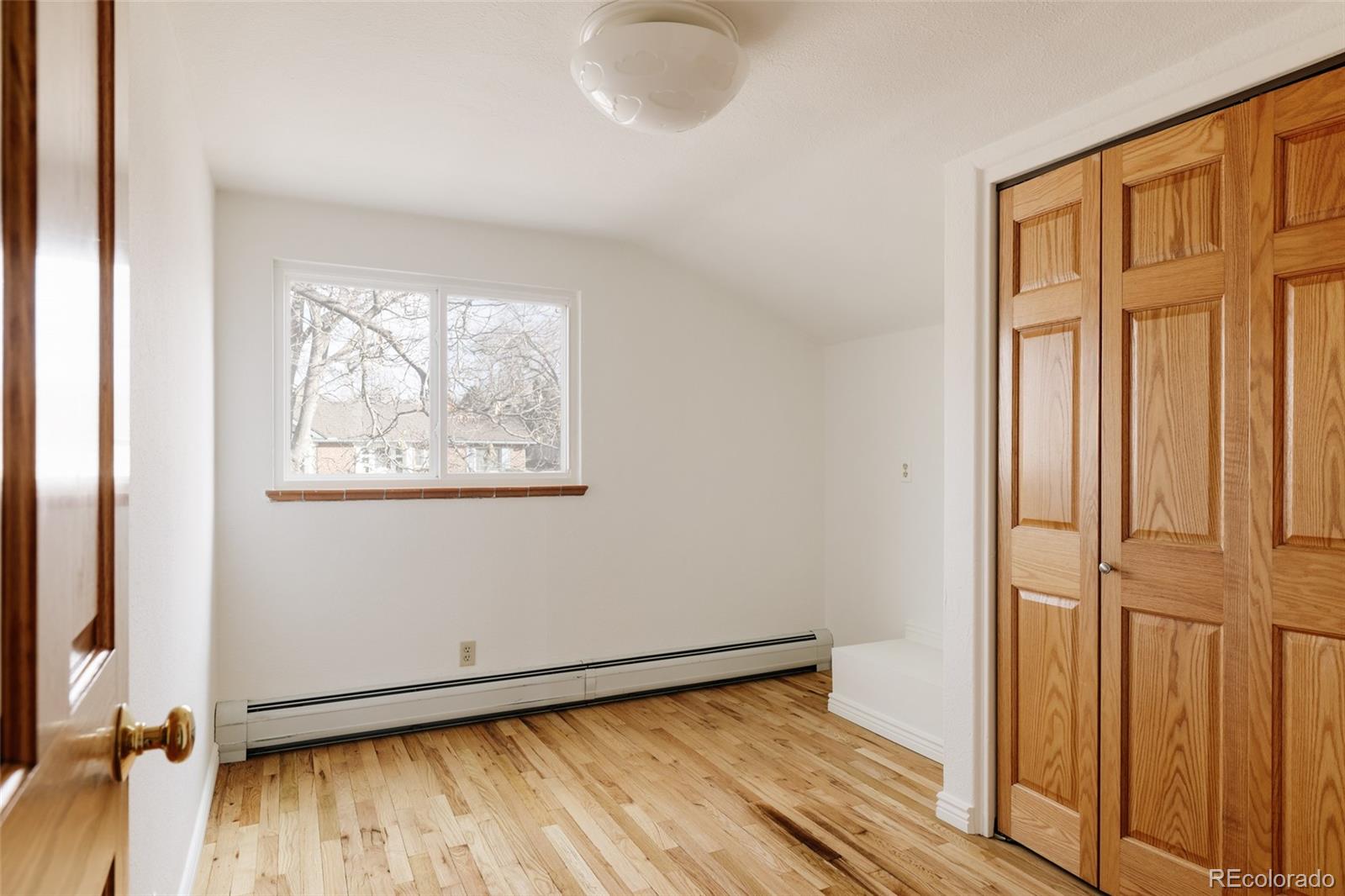 4035 Cody Street Wheat Ridge, CO 80033 - Photo 30 of 47 an empty room with wooden floor door and windows