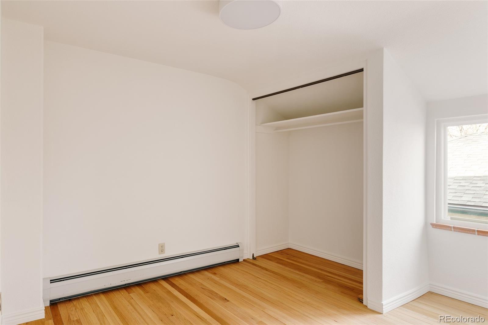 4035 Cody Street Wheat Ridge, CO 80033 - Photo 32 of 47 a view of empty room with wooden floor and fan