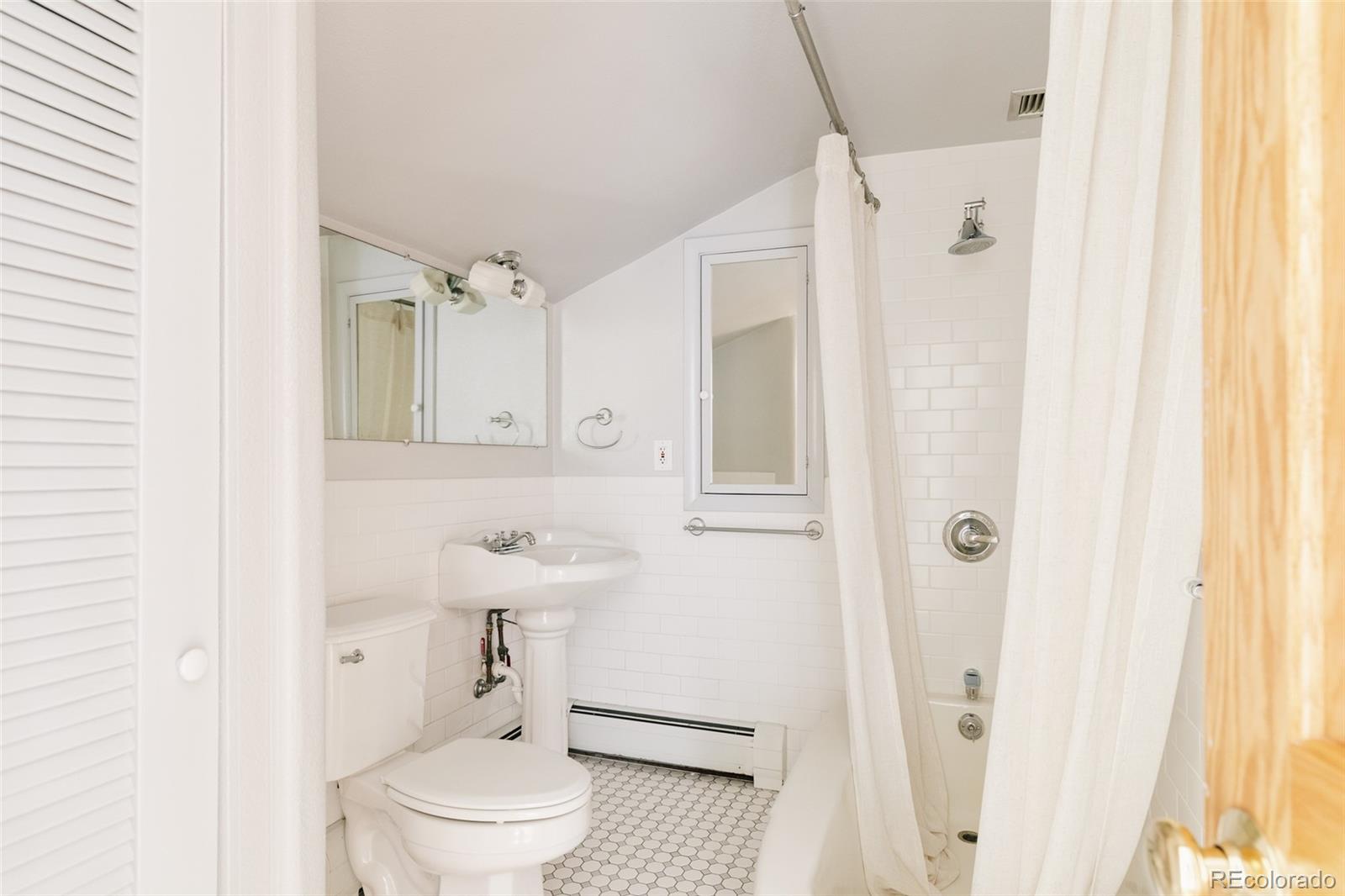 4035 Cody Street Wheat Ridge, CO 80033 - Photo 33 of 47 a bathroom with a sink a toilet and shower