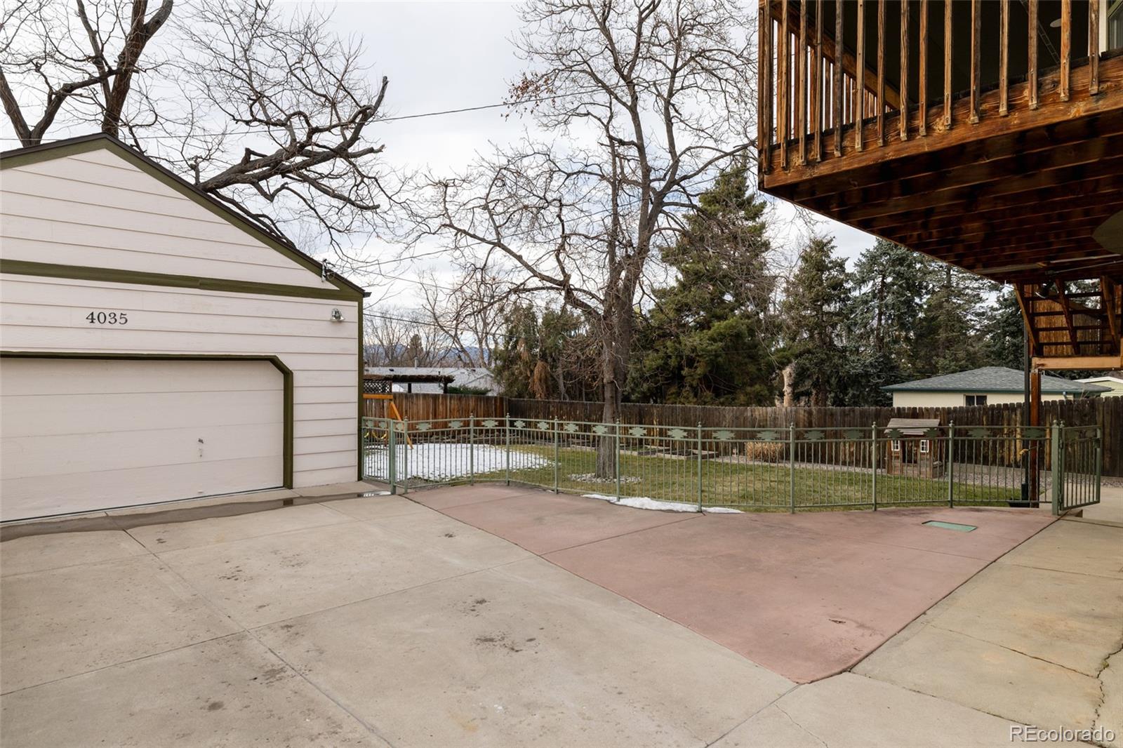 4035 Cody Street Wheat Ridge, CO 80033 - Photo 41 of 47 a view of a backyard with wooden fence