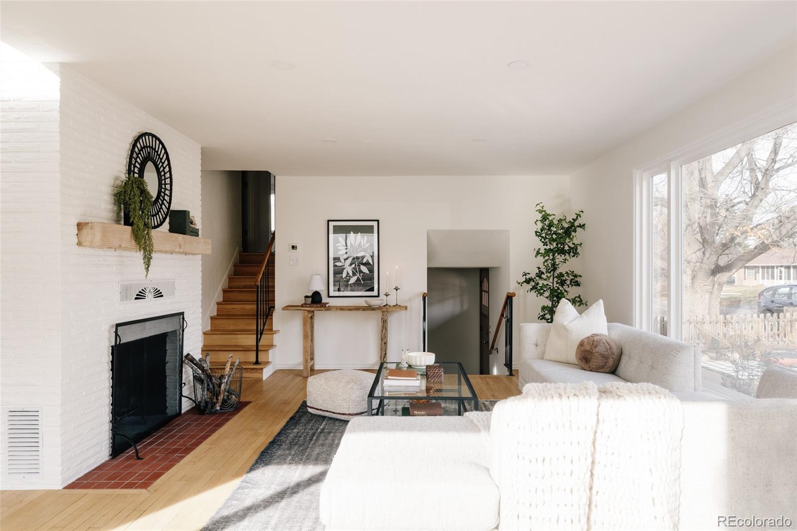 4035 Cody Street Wheat Ridge, CO 80033 - Photo 5 of 47 a living room with furniture a fireplace and a large window