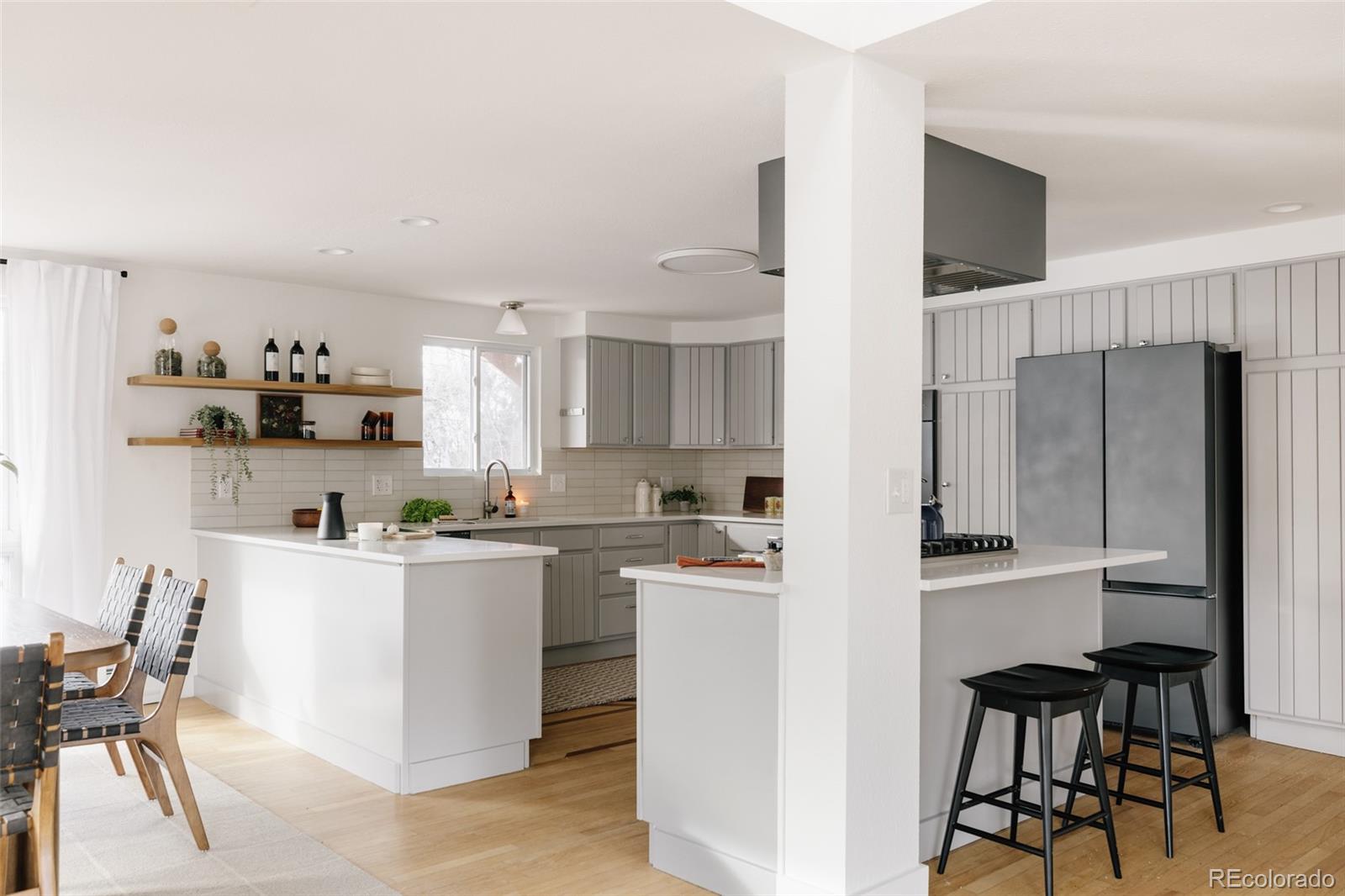 4035 Cody Street Wheat Ridge, CO 80033 - Photo 9 of 47 a kitchen with stainless steel appliances a refrigerator and wooden cabinets