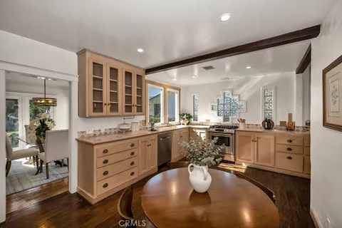 a kitchen with sink refrigerator and cabinets