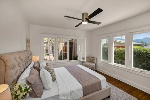 a bedroom with a large bed and a large window