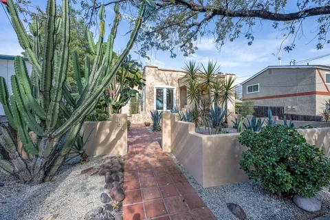 a view of a house with fountain and large trees
