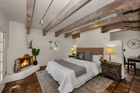 a spacious bedroom with a bed dresser and a window