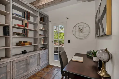 a living room with furniture and a painting on the wall