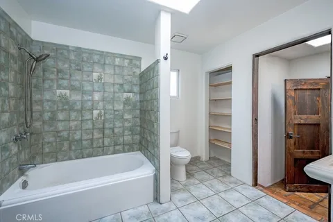 a bathroom with a bathtub and toilet