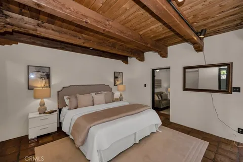 a bedroom with furniture and potted plants
