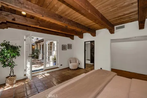 a bedroom with a bed and a mirror