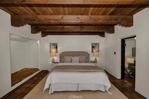 a living room with furniture potted plant and a large window