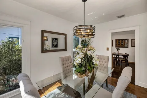 a view of a dining room with furniture wooden floor and chandelier