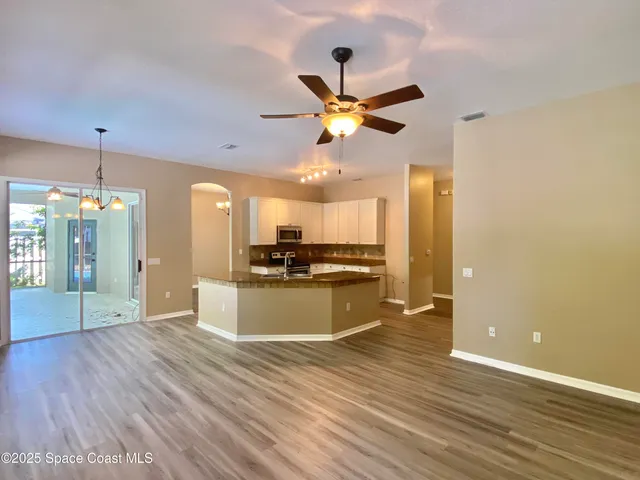 a view of a kitchen with a sink and a kitchen view