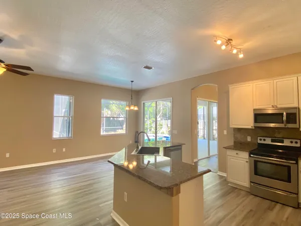 a kitchen with stainless steel appliances granite countertop a sink stove and oven