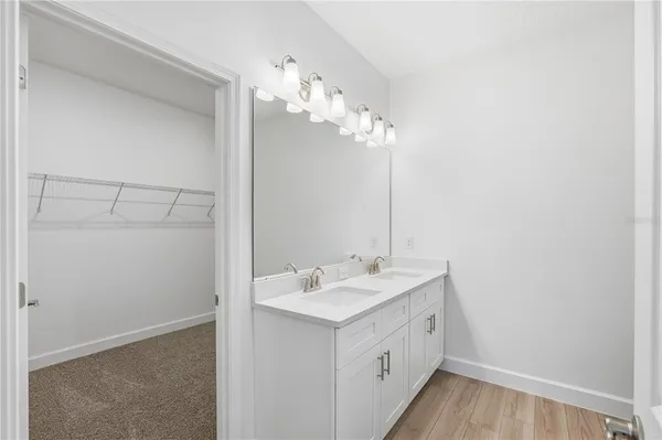 a spacious bathroom with a double vanity sink and a mirror