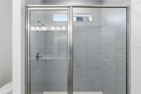 a bathroom with a glass shower door