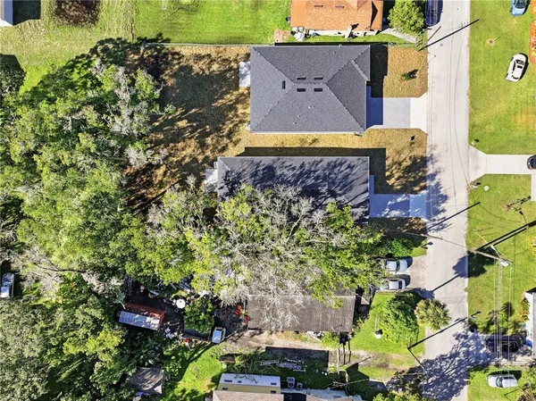 an aerial view of a house with a yard