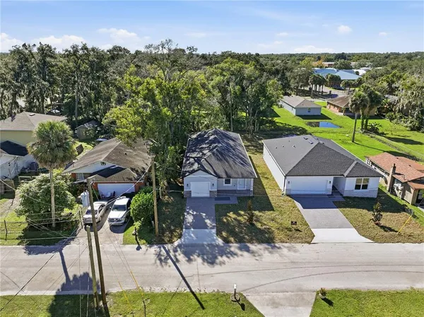 an aerial view of multiple houses with yard