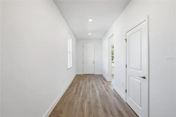 a view of a hallway with wooden floor