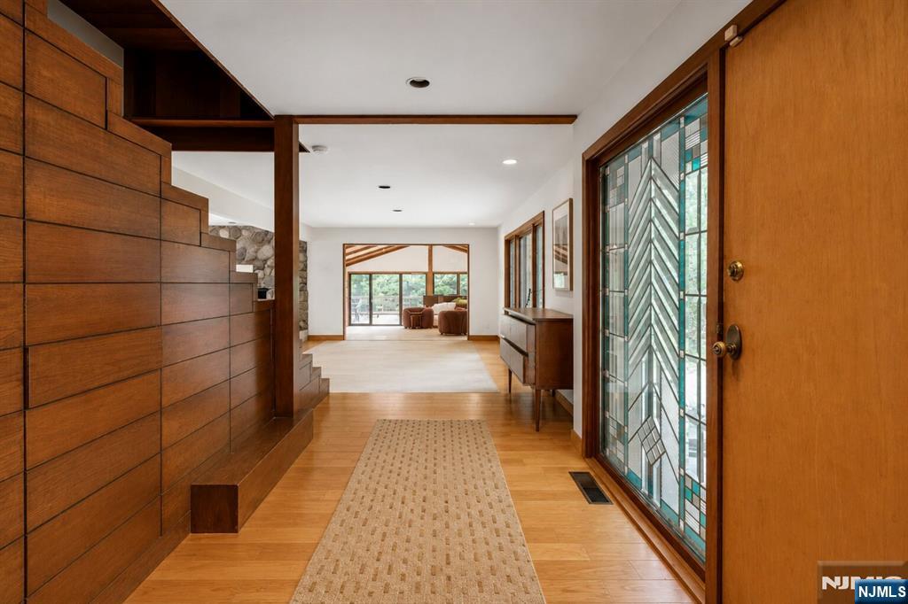 34 Cambridge Way Alpine, NJ 07620 - Photo 5 of 48 a hallway with a wooden floor and a large window