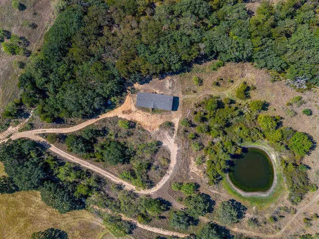 an aerial view of house with yard and outdoor seating