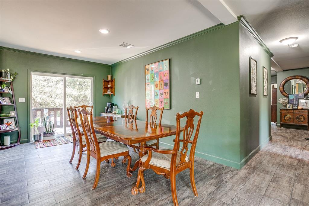 5878 Greenwood Road Millsap, TX 76066 - Photo 16 of 40 a view of a dining room with furniture window and wooden floor
