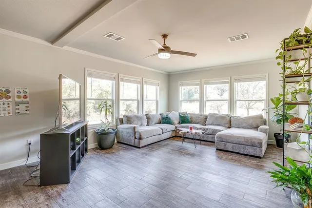 a living room with furniture and a large window