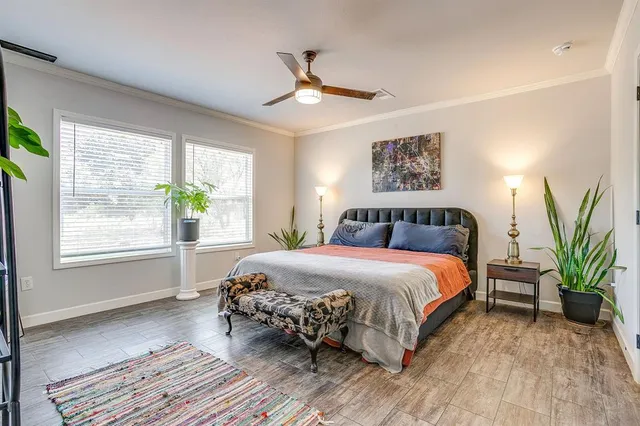 a bedroom with a large bed and a window